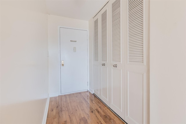 corridor with light hardwood / wood-style floors