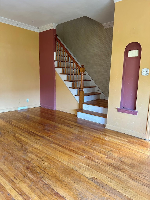 interior space featuring hardwood / wood-style flooring and ornamental molding