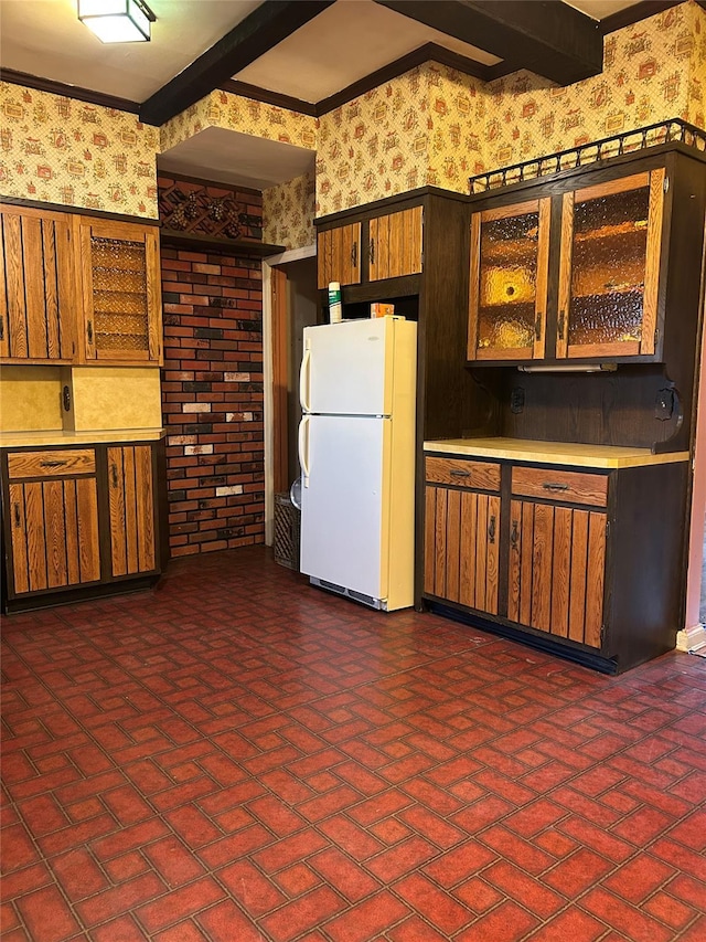 kitchen featuring beam ceiling and white fridge