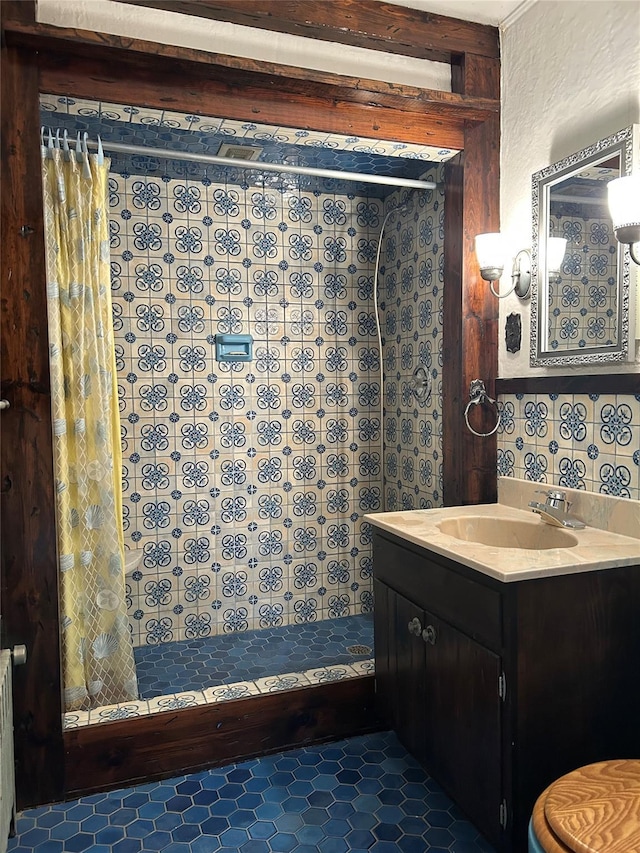 bathroom featuring tile patterned floors, vanity, and a shower with shower curtain