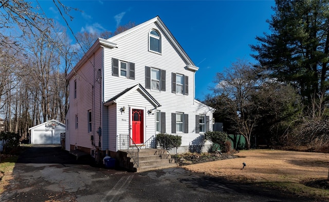 view of front of home with an outbuilding and a garage