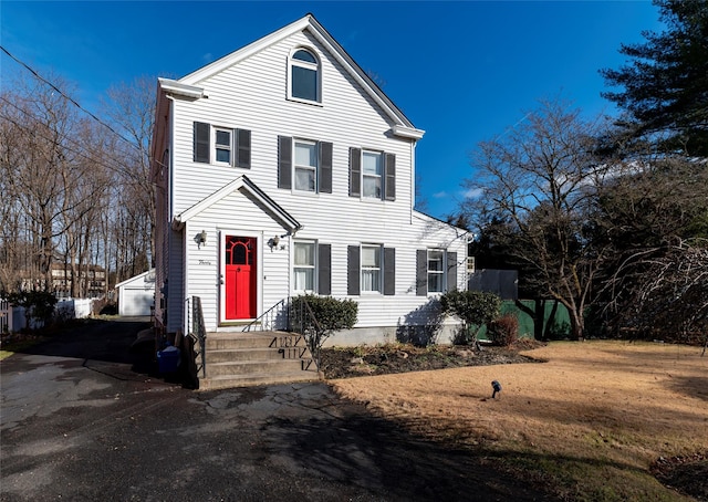 view of front of property with a garage and an outbuilding