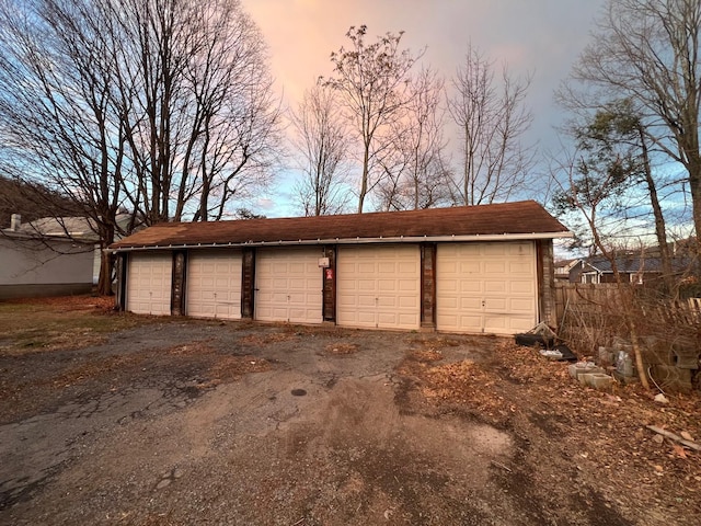 view of garage at dusk