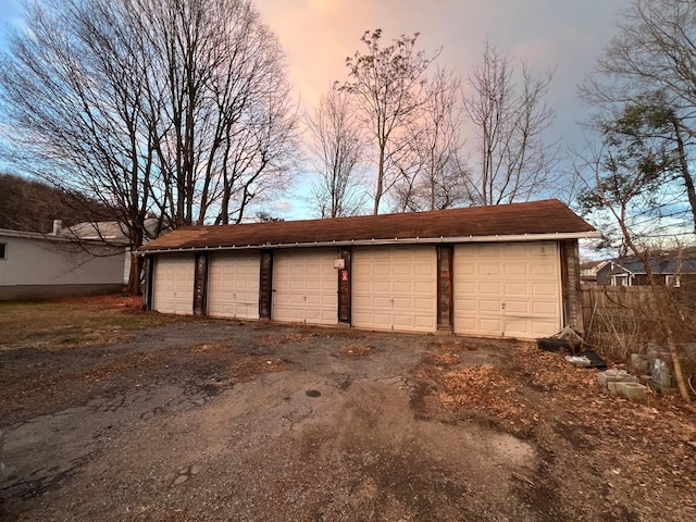 view of garage at dusk