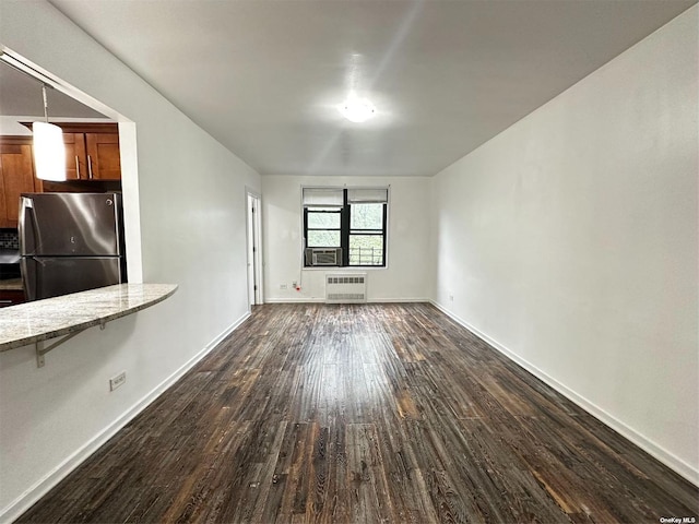 unfurnished living room with dark hardwood / wood-style flooring