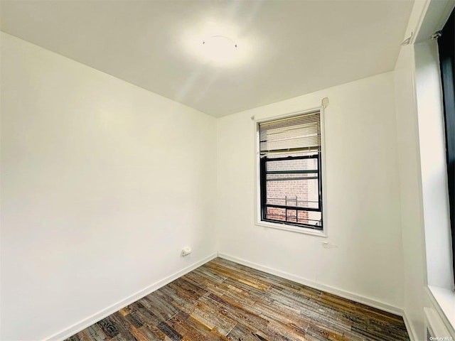 spare room with dark wood-type flooring