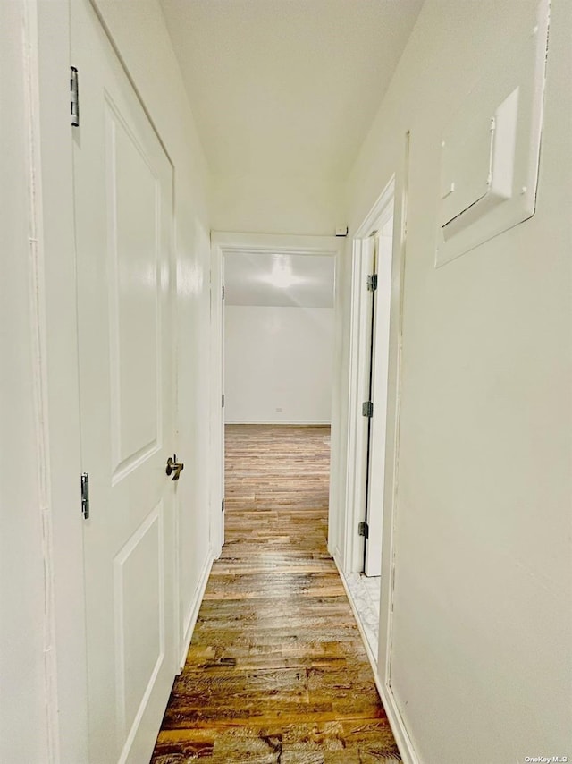 hallway with hardwood / wood-style flooring