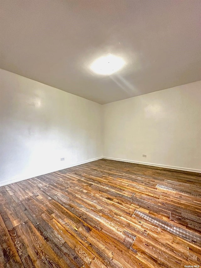 empty room featuring dark wood-type flooring