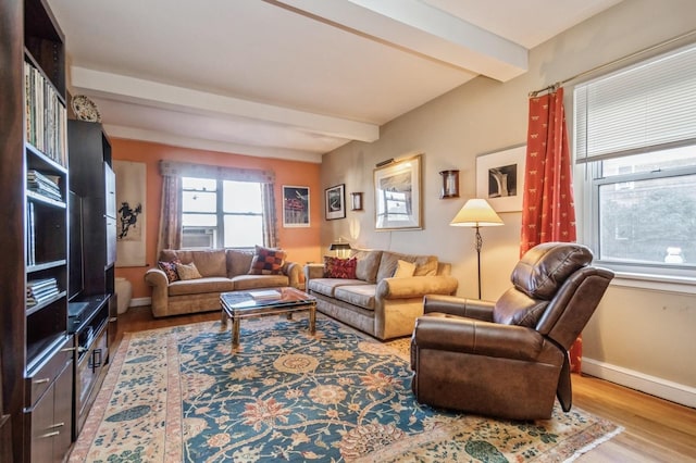 living room with beamed ceiling and wood-type flooring