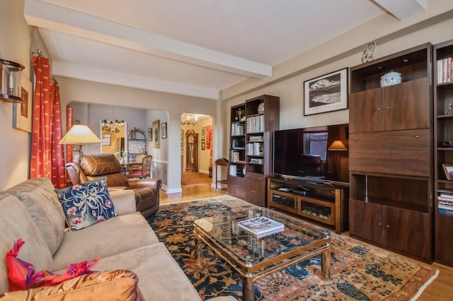 living room with beamed ceiling and wood-type flooring