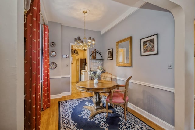 dining room featuring wood-type flooring and a notable chandelier