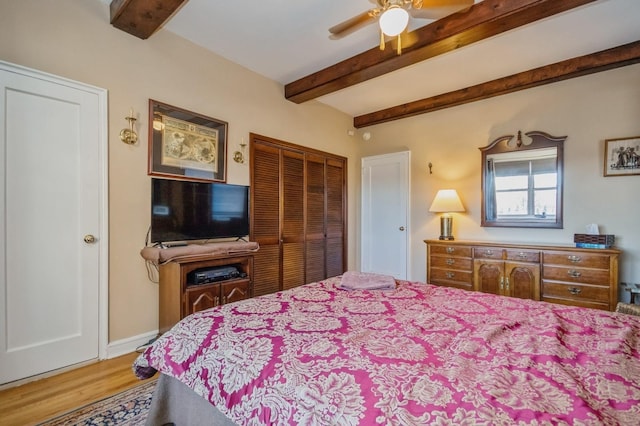 bedroom featuring ceiling fan, hardwood / wood-style floors, and beamed ceiling