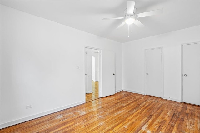 unfurnished bedroom with ceiling fan and light hardwood / wood-style floors