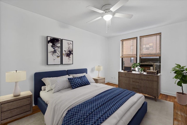 bedroom with light wood-type flooring and ceiling fan