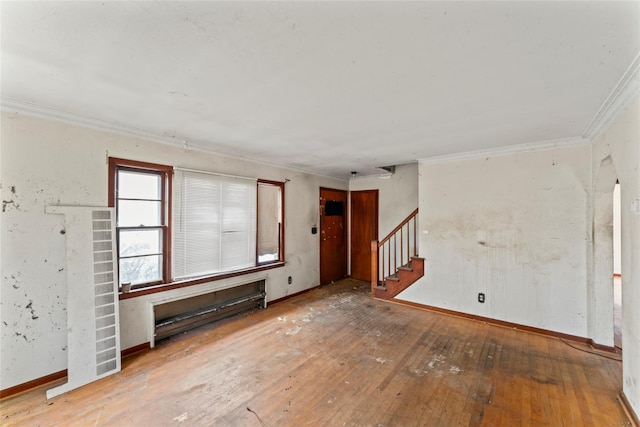 unfurnished living room featuring hardwood / wood-style floors, a baseboard radiator, and ornamental molding