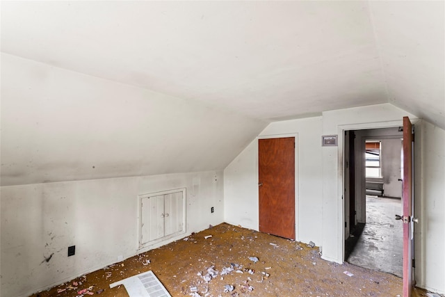 additional living space featuring vaulted ceiling