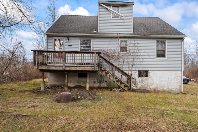 back of house featuring a yard and a wooden deck