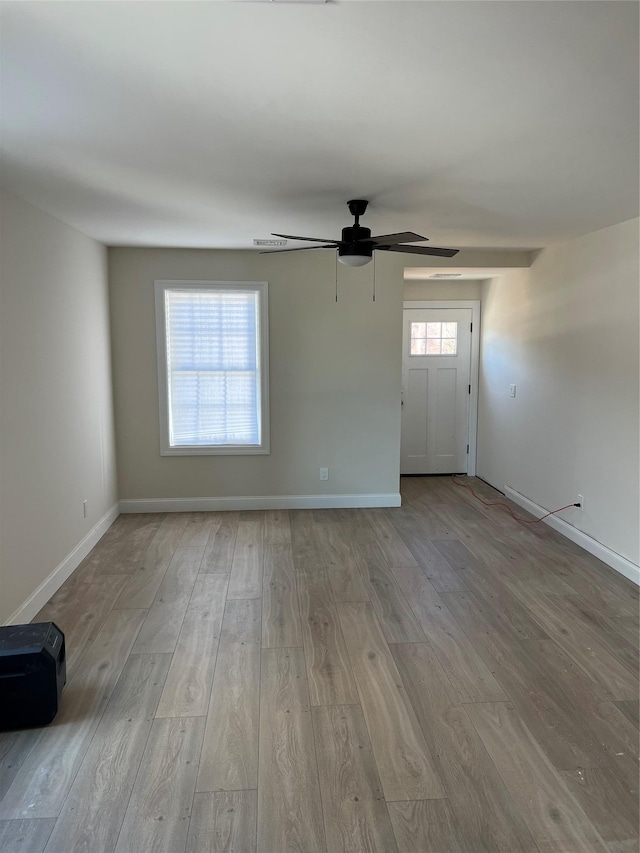 interior space with ceiling fan and light hardwood / wood-style flooring