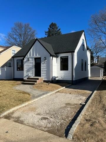 view of front facade featuring a garage and an outdoor structure