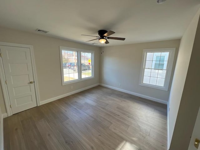 empty room featuring ceiling fan and light hardwood / wood-style floors