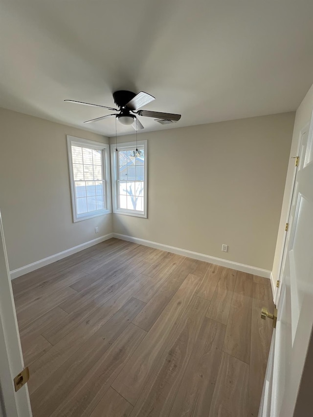 spare room with ceiling fan and wood-type flooring