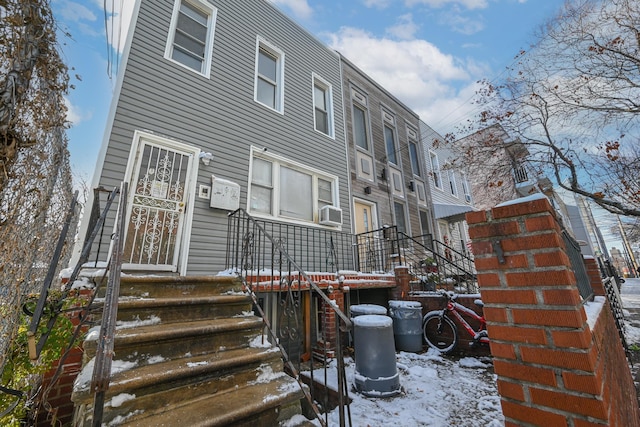 snow covered property with cooling unit