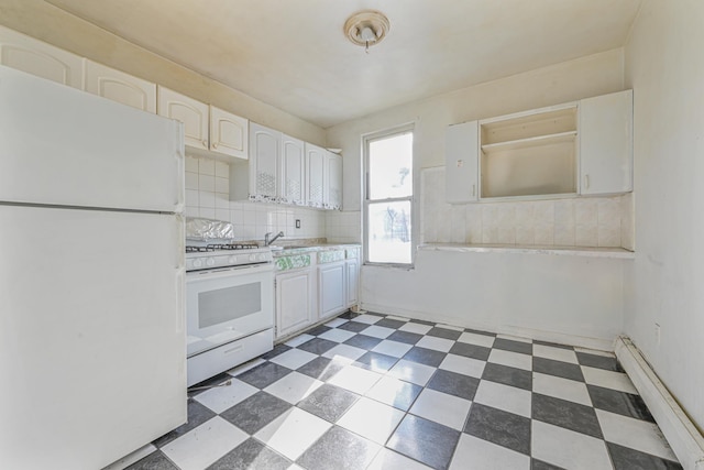 kitchen featuring decorative backsplash, white appliances, baseboard heating, sink, and white cabinetry