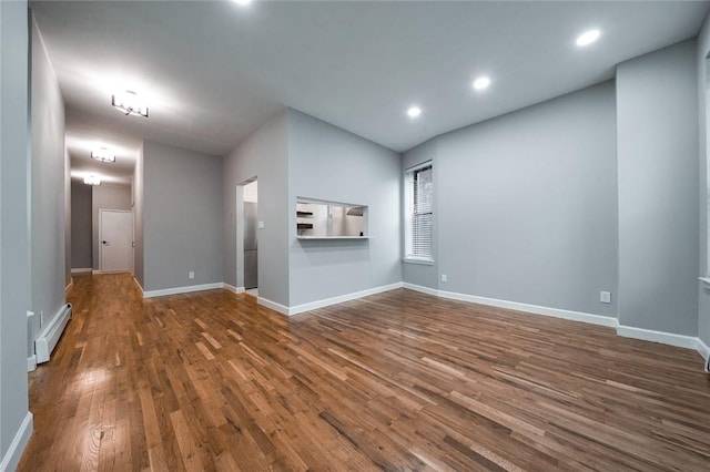 unfurnished living room with lofted ceiling, wood-type flooring, and baseboard heating