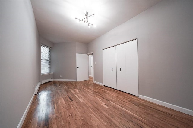 unfurnished bedroom featuring hardwood / wood-style floors and a closet