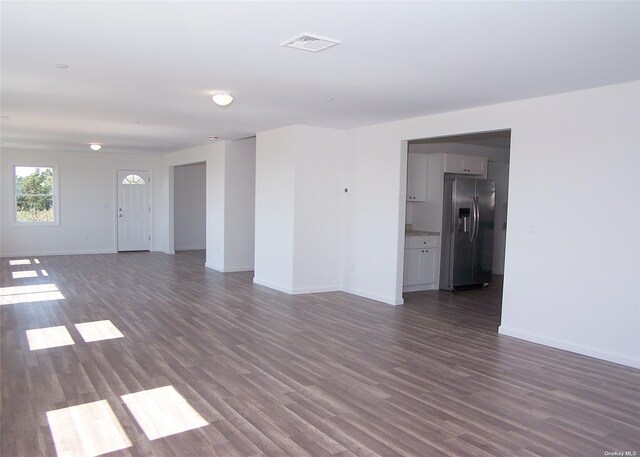 22 Rod St, East Patchogue, NY 11772 - unfurnished living room featuring visible vents, baseboards, and dark wood finished floors
