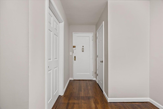 hall with dark hardwood / wood-style flooring