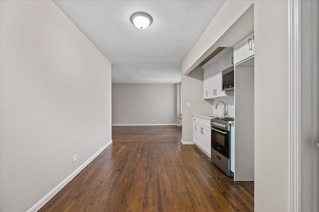 kitchen featuring white cabinets, stainless steel appliances, dark hardwood / wood-style floors, and sink