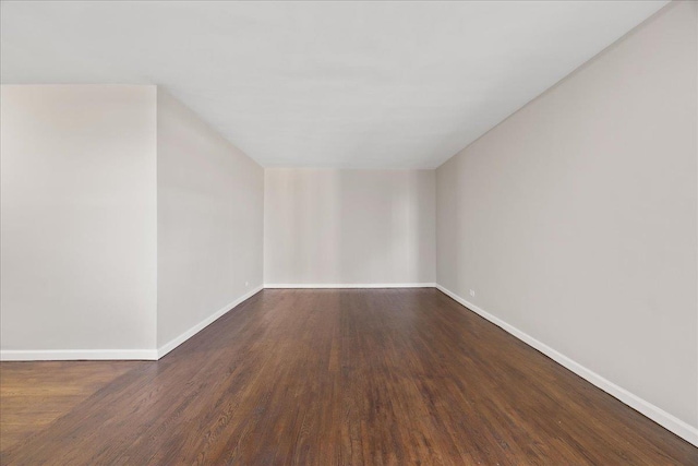 unfurnished room with dark hardwood / wood-style floors