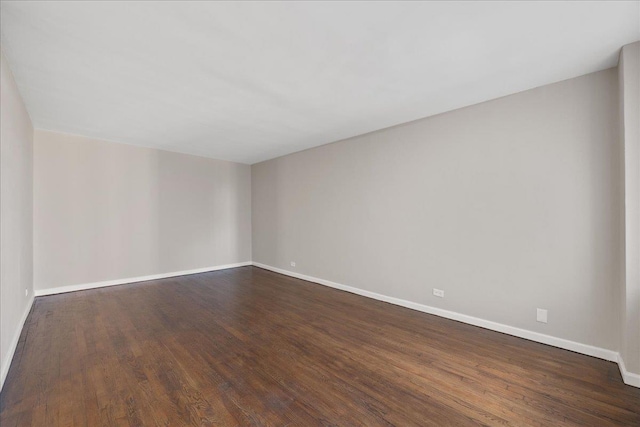 spare room with dark hardwood / wood-style flooring