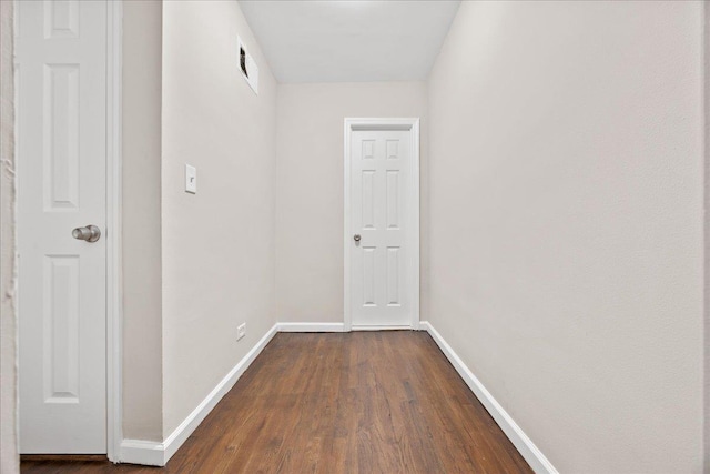 hall with dark wood-type flooring