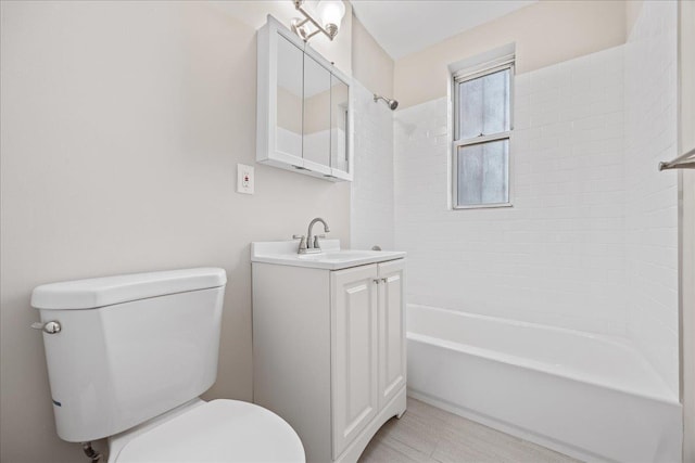 full bathroom with vanity, toilet, and tiled shower / bath combo