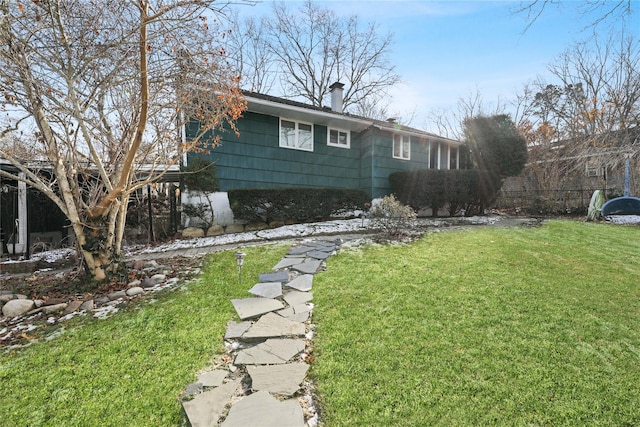 view of home's exterior with a lawn