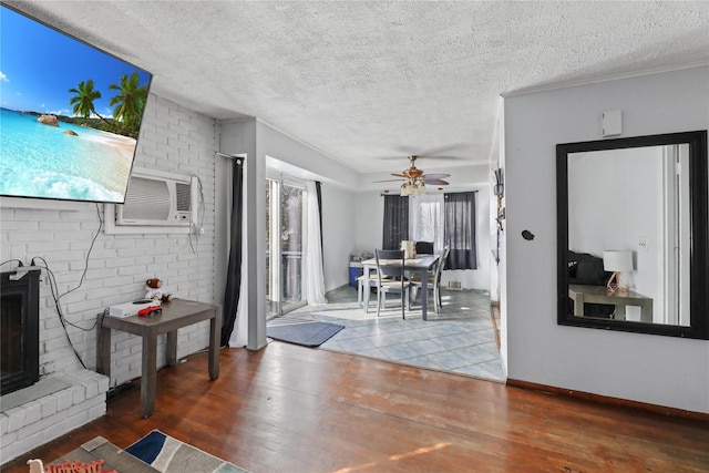 living room featuring a textured ceiling, hardwood / wood-style flooring, and ceiling fan