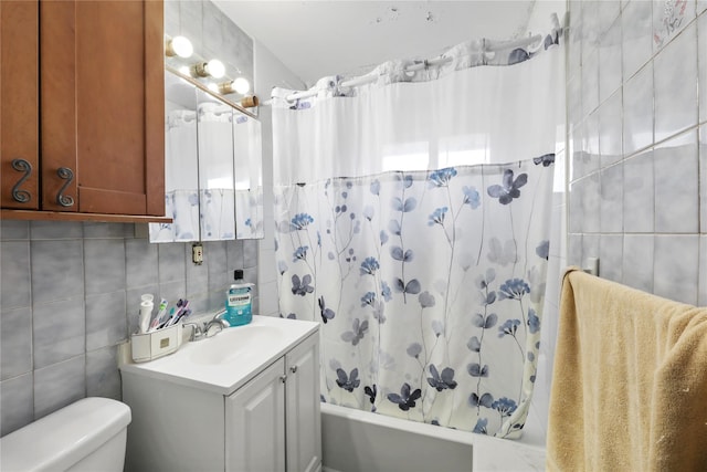 full bathroom featuring vanity, backsplash, toilet, tile walls, and shower / tub combo