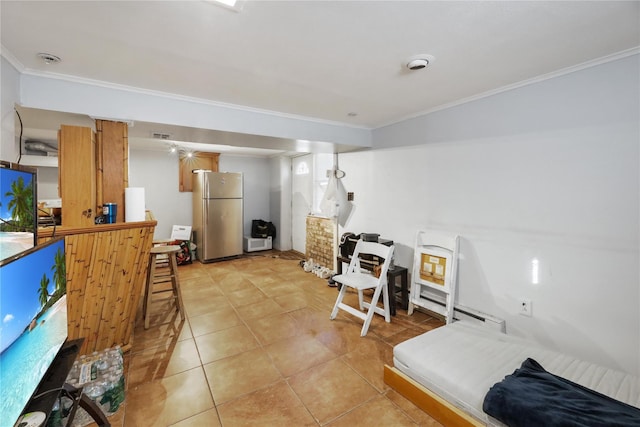 kitchen featuring stainless steel fridge, ornamental molding, and light tile patterned flooring