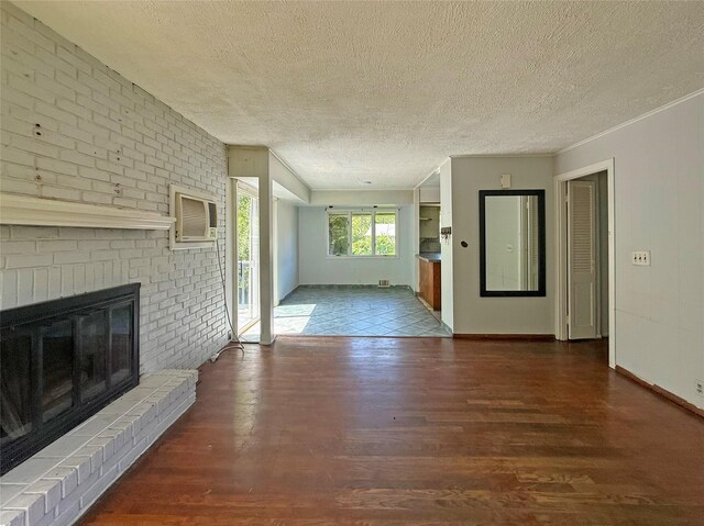 33 Birch Ct, Riverhead, NY 11901 - unfurnished living room with a textured ceiling, wood finished floors, a fireplace, an AC wall unit, and baseboards