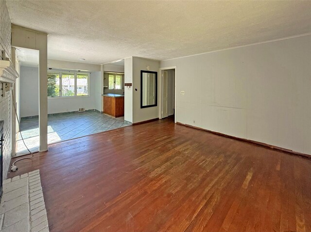 33 Birch Ct, Riverhead, NY 11901 - unfurnished living room featuring wood finished floors and a textured ceiling