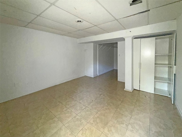 33 Birch Ct, Riverhead, NY 11901 - finished below grade area with a paneled ceiling and light tile patterned floors