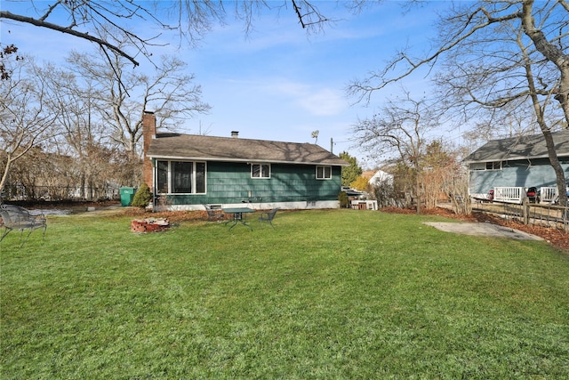 33 Birch Ct, Riverhead, NY 11901 - rear view of property featuring a chimney and a yard