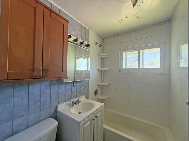 33 Birch Ct, Riverhead, NY 11901 - full bath featuring toilet, vanity, tile walls, shower / tub combination, and backsplash