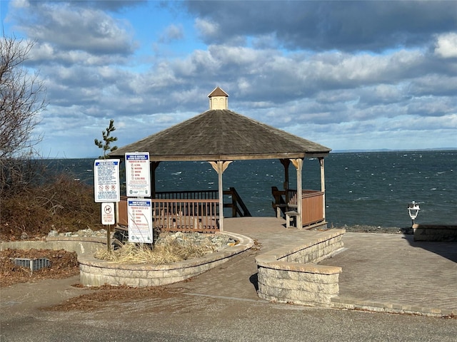 surrounding community with a gazebo and a water view