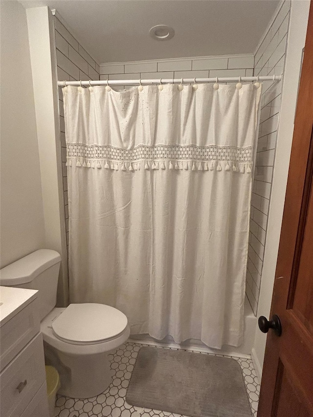 full bathroom with toilet, vanity, tile patterned floors, and shower / bath combo with shower curtain