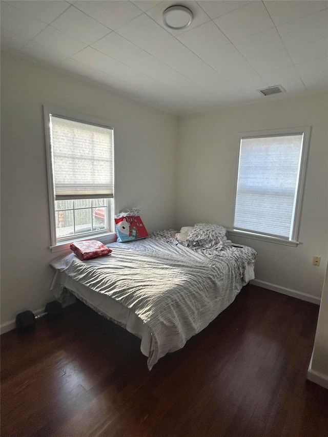 bedroom featuring dark hardwood / wood-style flooring