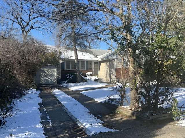 view of front of property featuring aphalt driveway and an attached garage