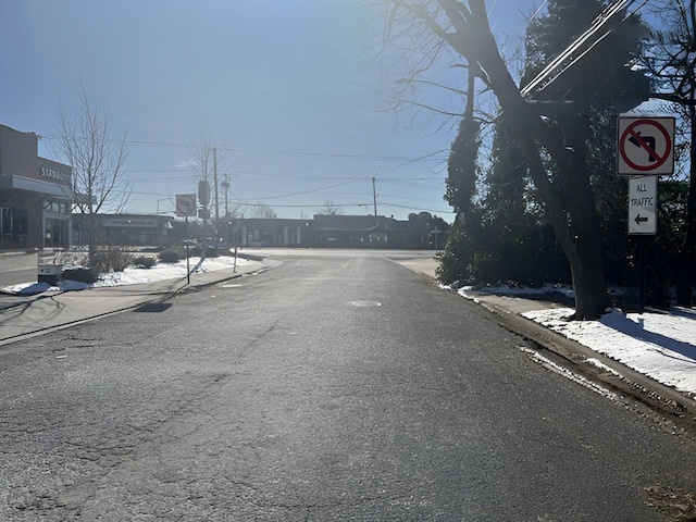 view of street featuring traffic signs and sidewalks